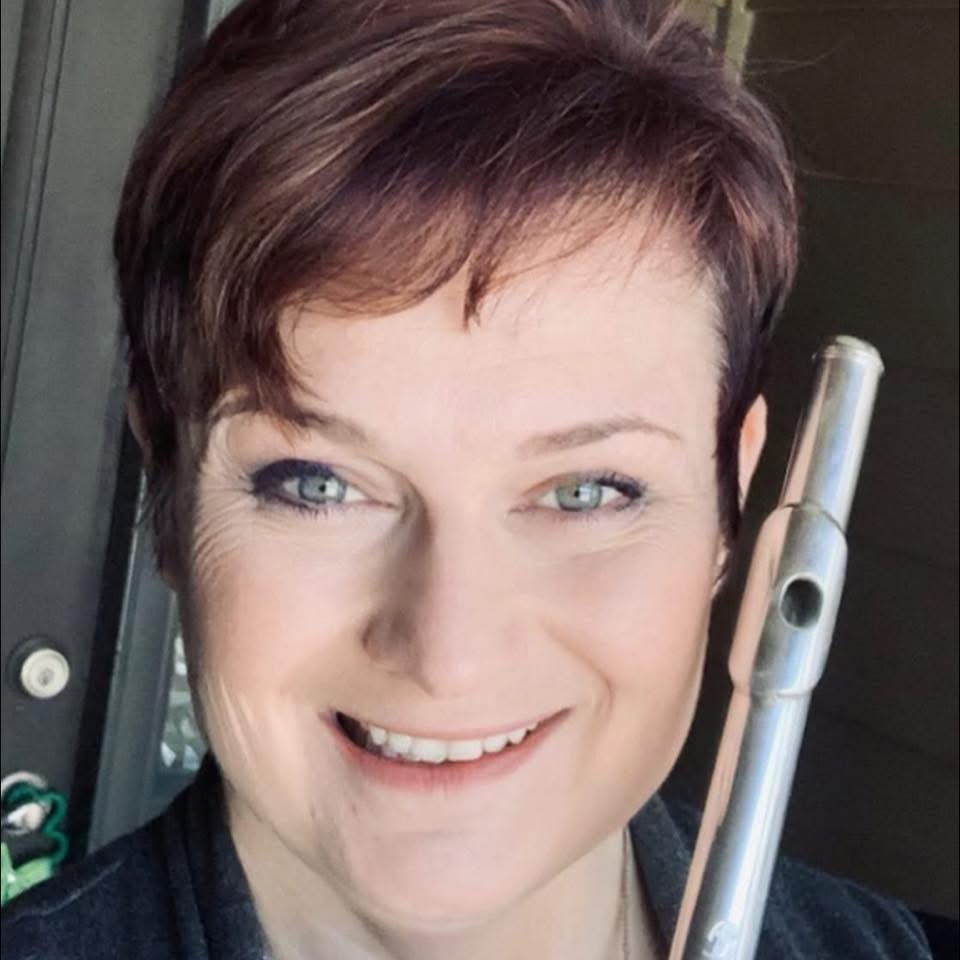 Flutist and instructor Christine Moore holding her flute