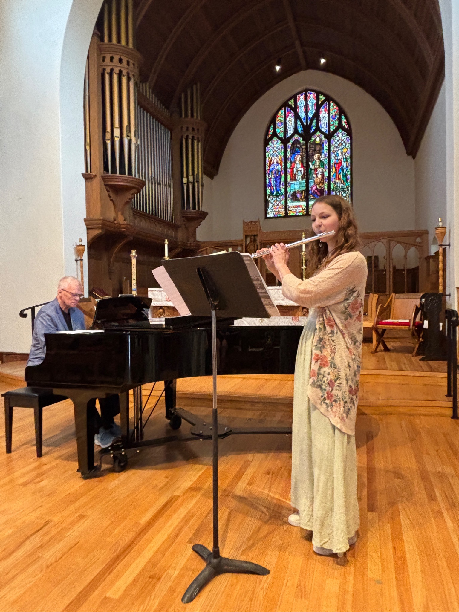 Flute soloist performing with piano in a church